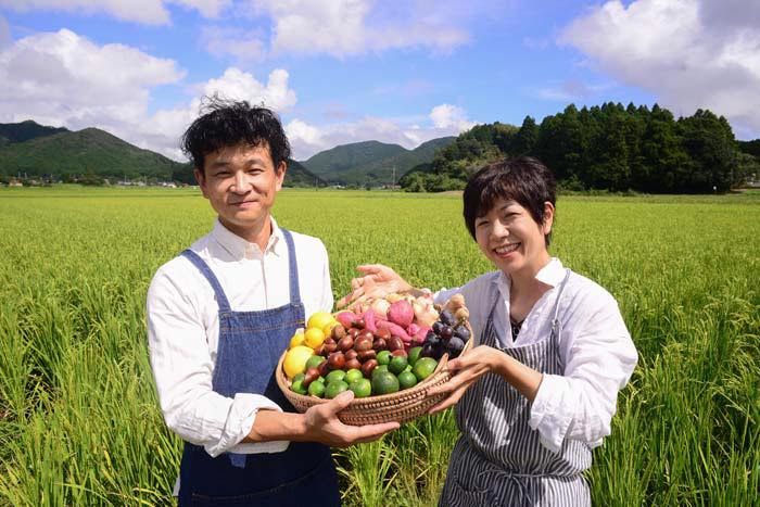 写真：色とりどりのフルーツを持ったカゴノオトの前と小清水です